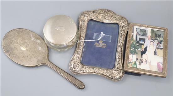 Two silver photograph frames, including early 20th century with Reynolds Angels, a silver mounted jar and hand mirror.